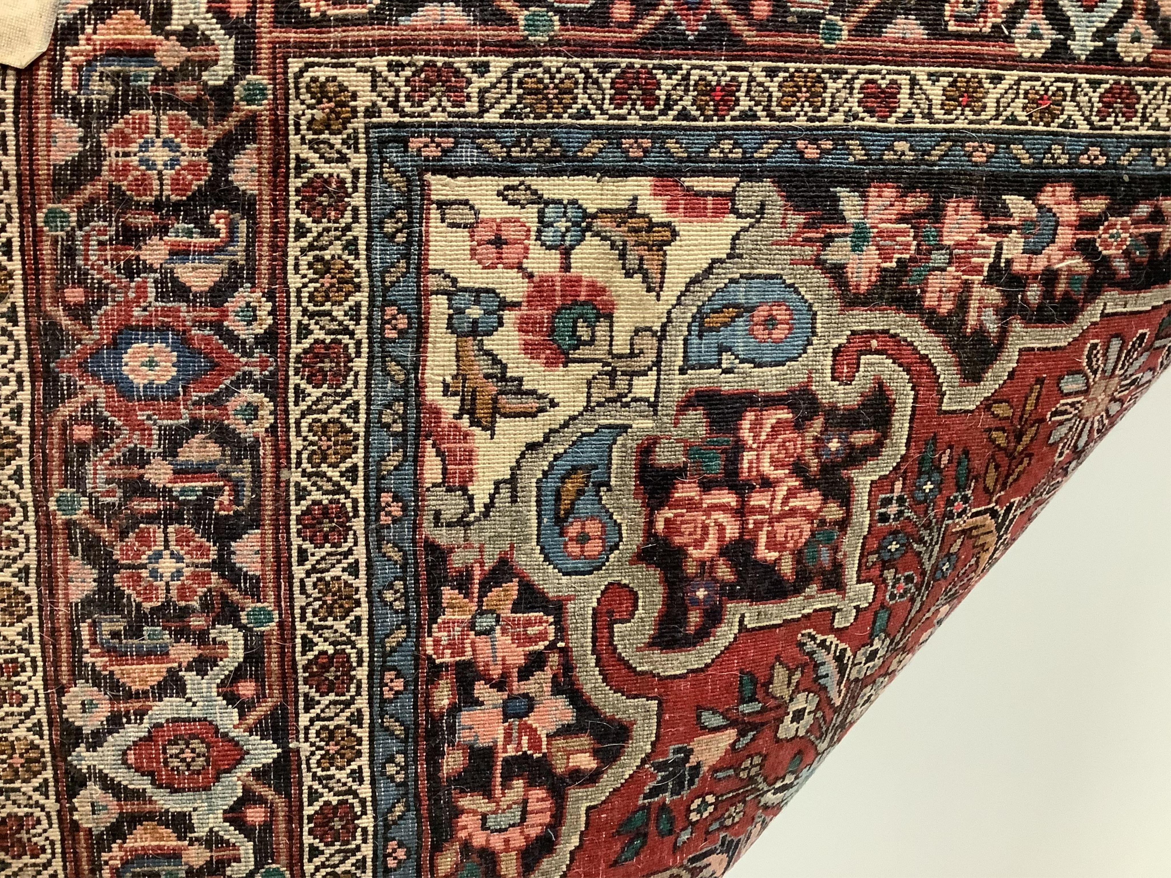 A Tabriz red ground rug, 166cm x 114cm. Condition - fair, lower third faded.